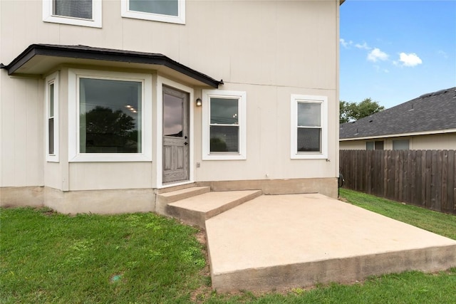 234 Saint Marys Dr, Hutto, TX 78634 - view of exterior entry featuring fence, a lawn, and a patio area