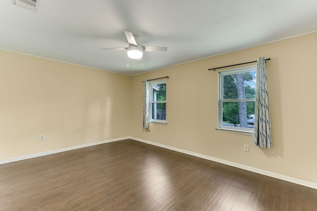 11600 Eubank Dr, Austin, TX 78758 - unfurnished room with healthy amount of natural light, a ceiling fan, and dark wood finished floors