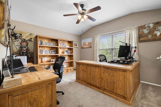 home office with baseboards, ceiling fan, vaulted ceiling, and light colored carpet