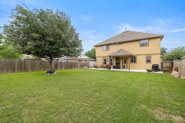 back of house with a fenced backyard, a patio, and a yard