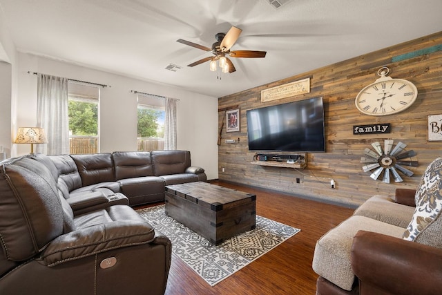12616 Wayne Spur Ln, Elgin, TX 78621 - living area with wooden walls, ceiling fan, wood finished floors, and an accent wall