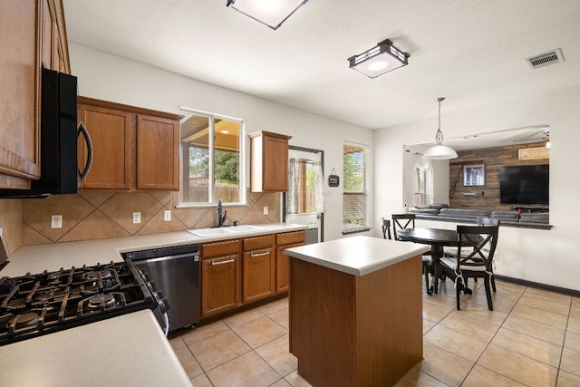 12616 Wayne Spur Ln, Elgin, TX 78621 - kitchen featuring a sink, black appliances, light countertops, and tasteful backsplash