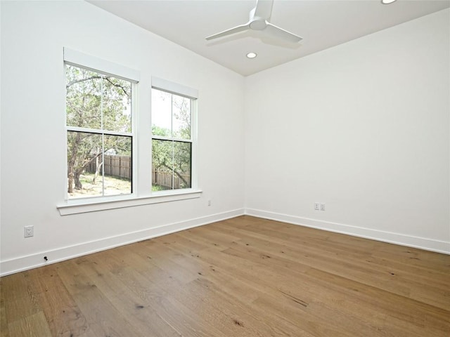 spare room with baseboards, ceiling fan, recessed lighting, and wood finished floors