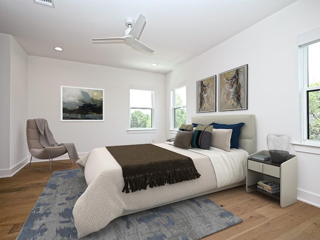 bedroom featuring a ceiling fan, visible vents, wood finished floors, baseboards, and recessed lighting
