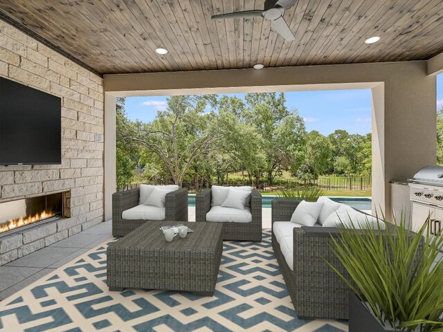 view of patio / terrace with fence, a ceiling fan, and an outdoor living space with a fireplace