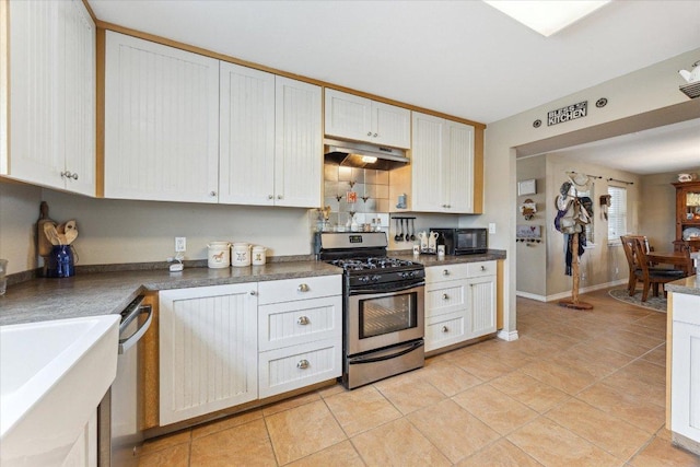 2334 County Road 464, Elgin, TX 78621 - kitchen featuring light tile patterned floors, dark countertops, stainless steel appliances, and under cabinet range hood
