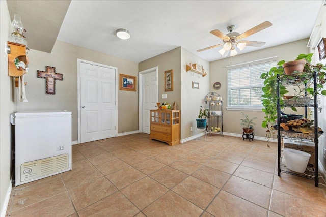 2334 County Road 464, Elgin, TX 78621 - interior space featuring light tile patterned floors, baseboards, and ceiling fan