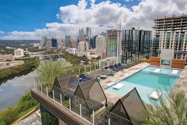 community pool with a patio, a water view, and a city view