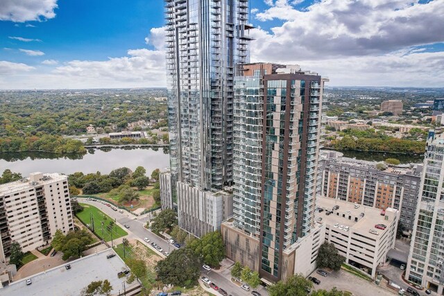 birds eye view of property featuring a water view and a city view