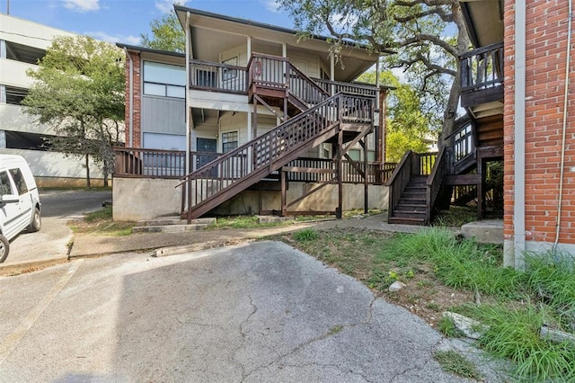back of house featuring stairs