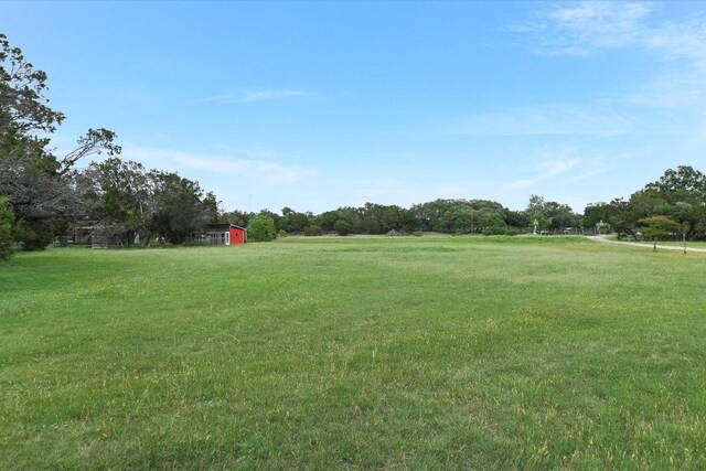 view of yard featuring an outdoor structure and a rural view