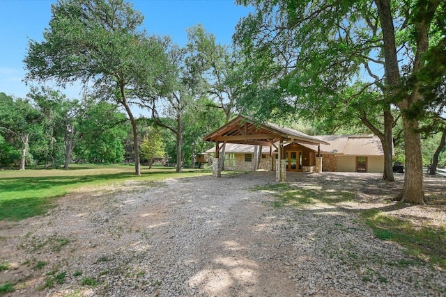 view of home's community with gravel driveway