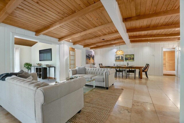 living area featuring wood ceiling, light tile patterned floors, and beam ceiling
