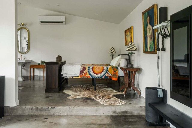 sitting room with an AC wall unit, finished concrete floors, and lofted ceiling