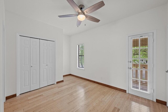 unfurnished bedroom with light wood-style floors, baseboards, access to outside, and a closet