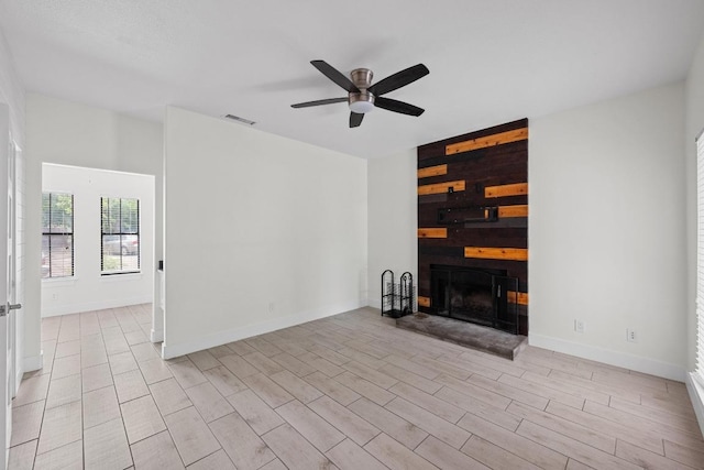 4401 Speedway St Unit 114, Austin, TX 78751 - unfurnished living room with a ceiling fan, a fireplace, light wood finished floors, and baseboards