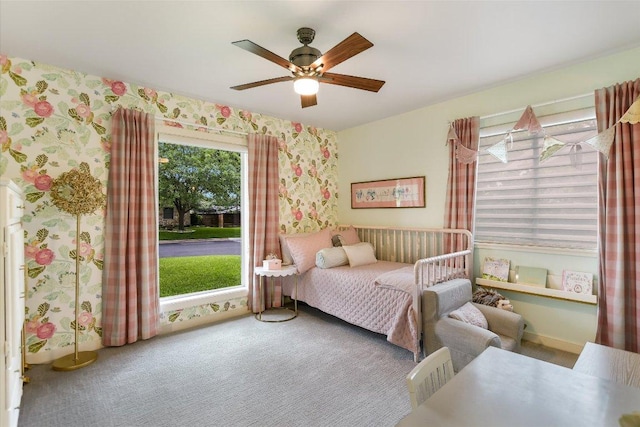 carpeted bedroom with wallpapered walls and ceiling fan