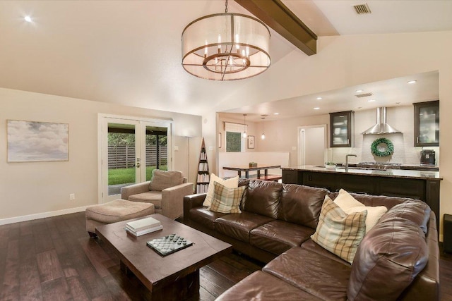 living area featuring beamed ceiling, dark wood-style floors, a chandelier, and visible vents
