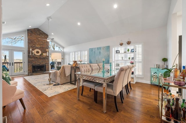 3605 Fawn Creek Path, Austin, TX 78746 - dining area with high vaulted ceiling, a stone fireplace, hardwood / wood-style floors, recessed lighting, and a ceiling fan