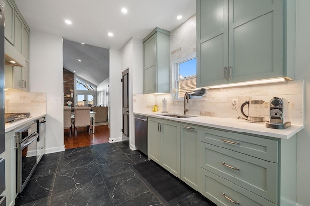3605 Fawn Creek Path, Austin, TX 78746 - kitchen featuring green cabinetry, appliances with stainless steel finishes, light countertops, vaulted ceiling, and recessed lighting