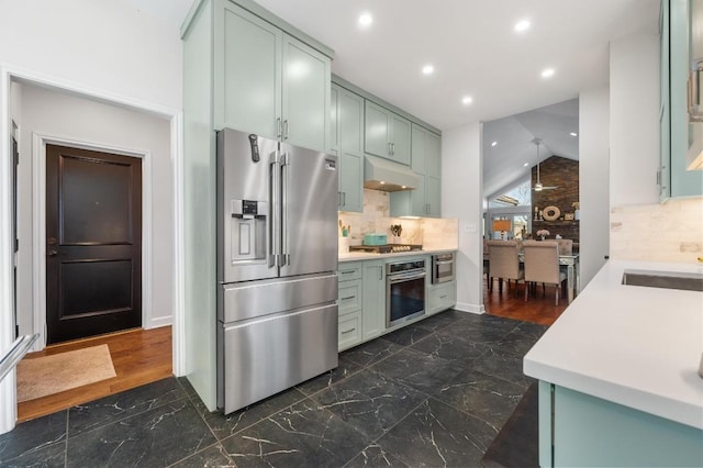 3605 Fawn Creek Path, Austin, TX 78746 - kitchen with appliances with stainless steel finishes, lofted ceiling, light countertops, tasteful backsplash, and recessed lighting