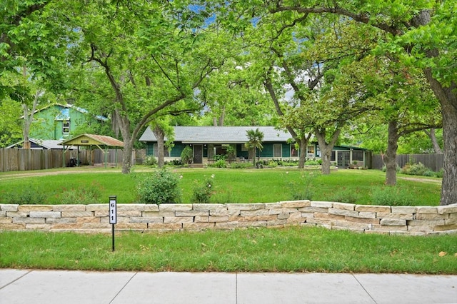 view of front of house with fence and a front yard