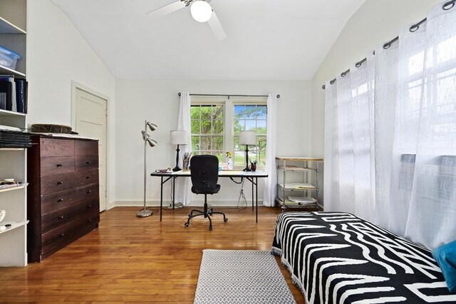 bedroom with wood finished floors, a ceiling fan, and lofted ceiling