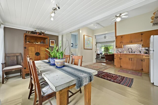 dining room with a ceiling fan, light wood-style flooring, and rail lighting