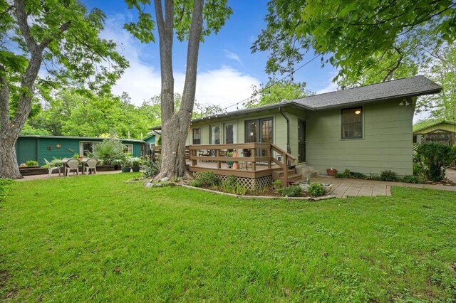 back of house featuring a yard, a deck, and a patio area