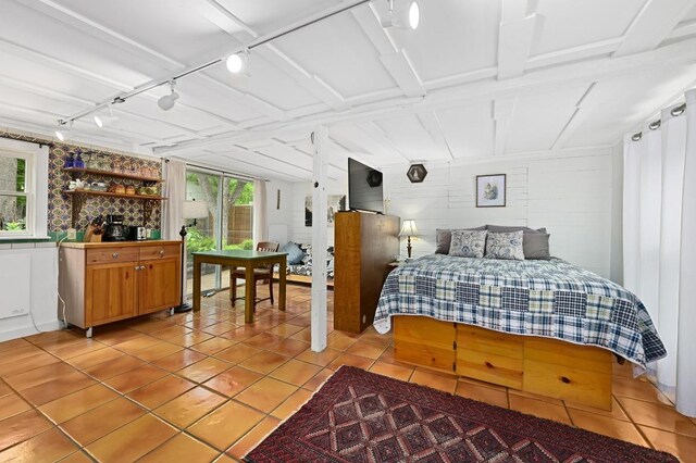 bedroom featuring multiple windows and light tile patterned floors