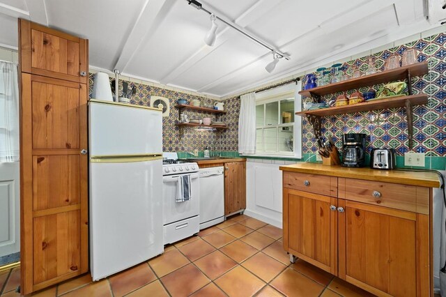 kitchen featuring open shelves, white appliances, rail lighting, butcher block countertops, and light tile patterned floors