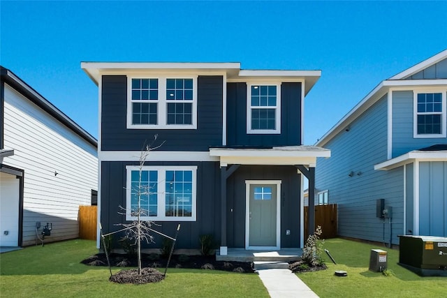 view of front of home with a front lawn, board and batten siding, and fence