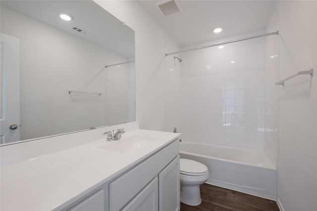 bathroom with toilet, visible vents, wood finished floors, and vanity
