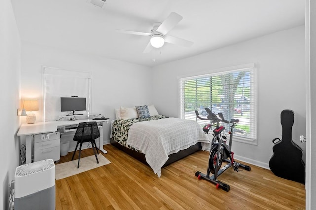 bedroom with baseboards, ceiling fan, and light wood finished floors