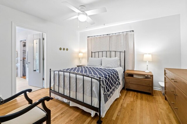 bedroom featuring light wood-style floors and a ceiling fan