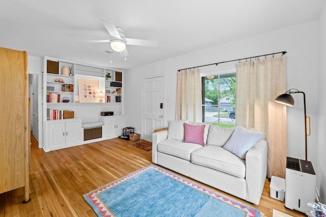 living area featuring a ceiling fan and wood finished floors