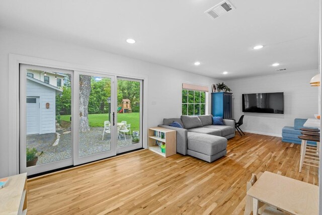 living room featuring recessed lighting, light wood finished floors, and visible vents