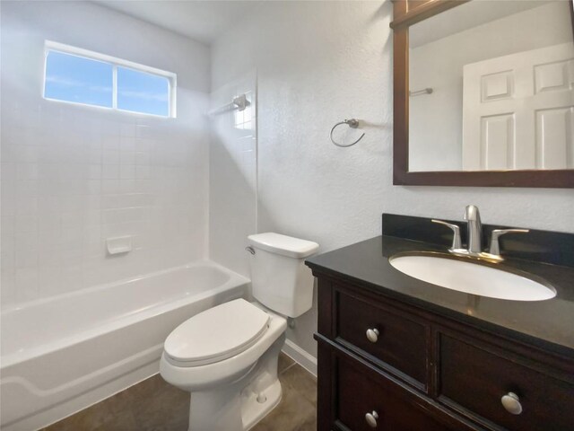 full bathroom with vanity, baseboards, tub / shower combination, and toilet