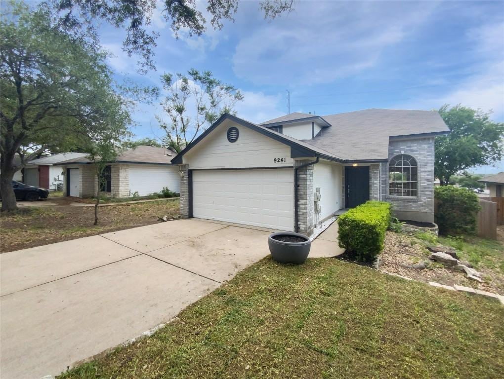 9241 Vigen Cir, Austin, TX 78748 - ranch-style house featuring an attached garage, concrete driveway, and brick siding