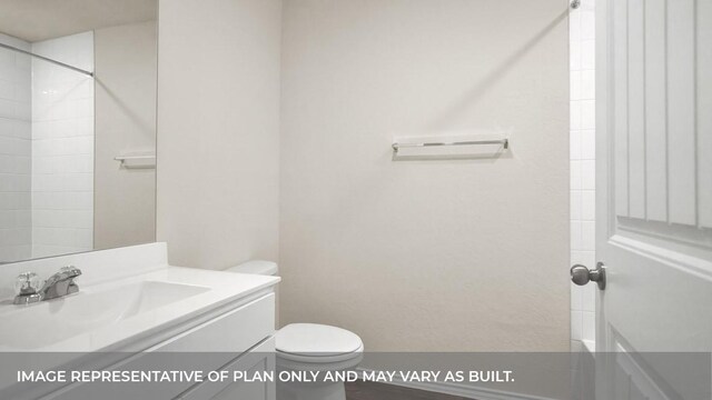 bathroom featuring vanity, toilet, and a shower