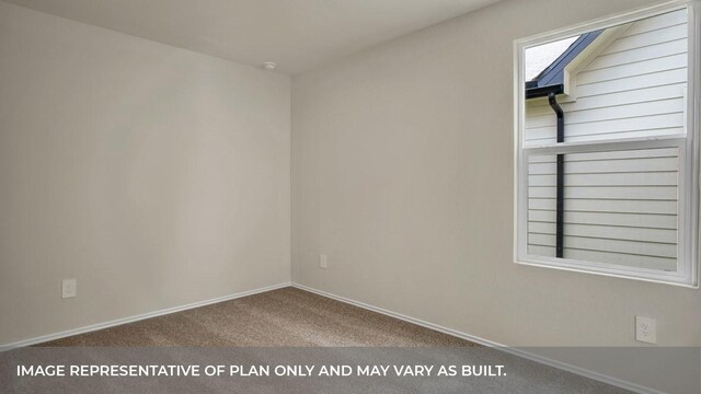 carpeted empty room featuring baseboards