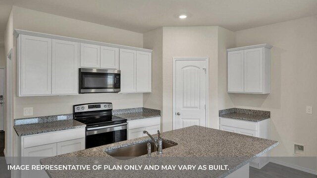 kitchen featuring a sink, white cabinets, stone countertops, stainless steel appliances, and recessed lighting