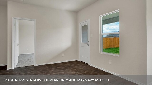 unfurnished room with baseboards and dark wood finished floors