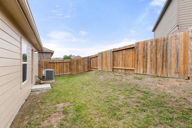 view of yard with a fenced backyard and cooling unit