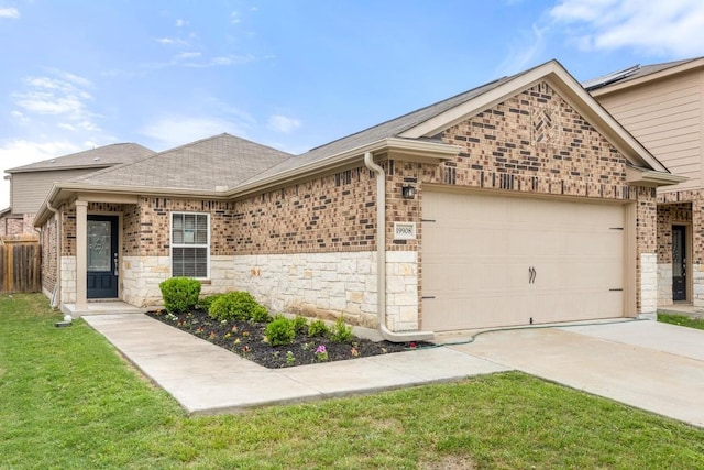 ranch-style home featuring a garage, driveway, brick siding, and stone siding