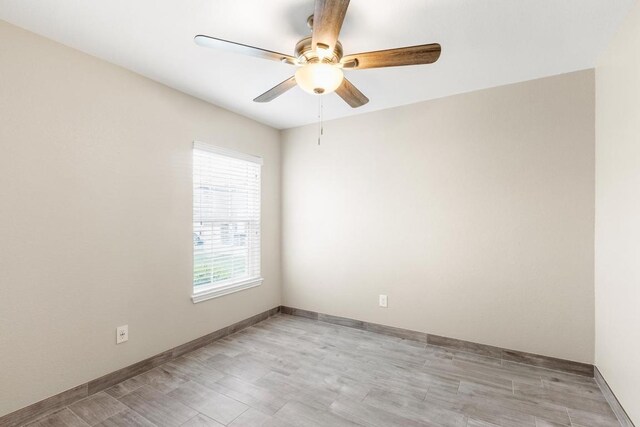 unfurnished room with baseboards and a ceiling fan