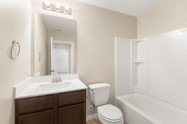 full bath with toilet, visible vents, washtub / shower combination, and vanity