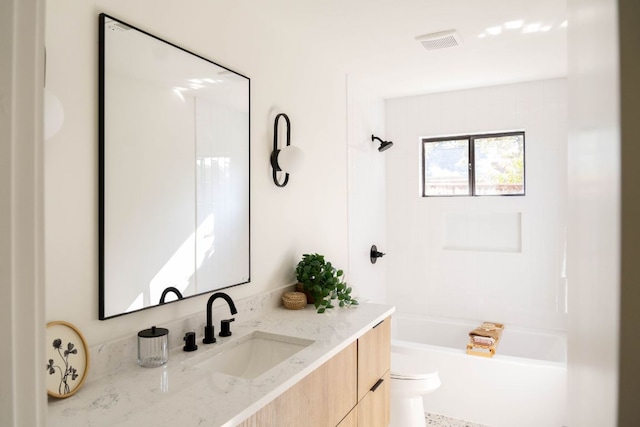 full bathroom with toilet, visible vents, washtub / shower combination, and vanity