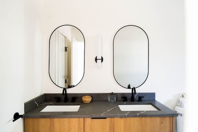 bathroom with a sink and double vanity