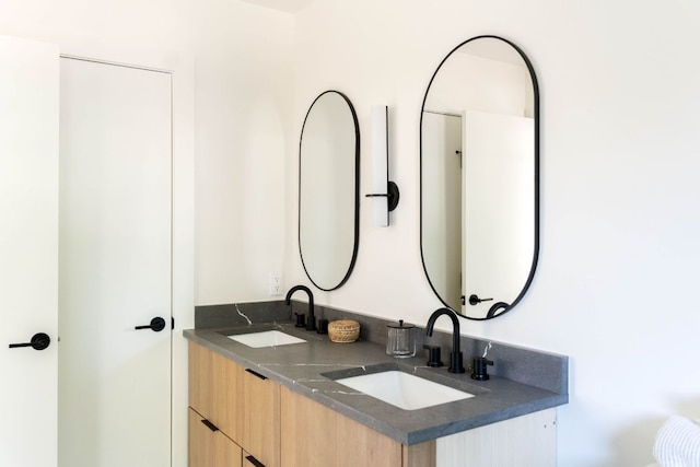 bathroom featuring double vanity and a sink